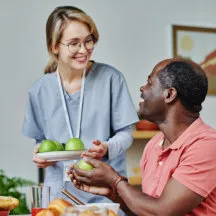 caregiver giving fruits