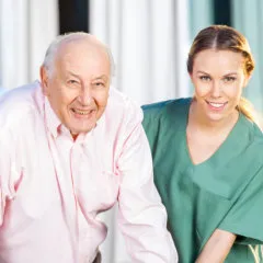 caregiver helping senior to walk