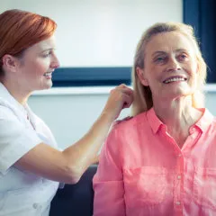 woman brushing seniors hair