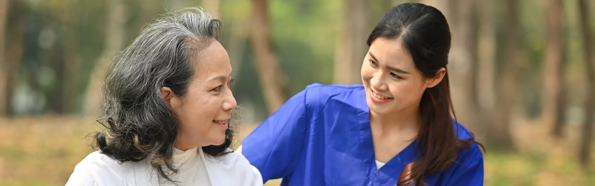 caregiver helping senior to walk