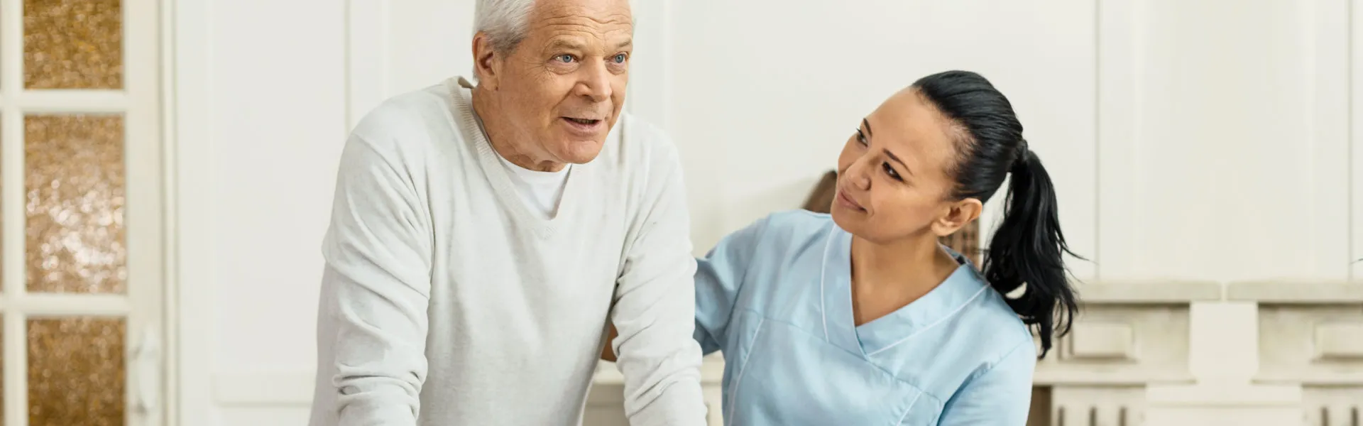 caregiver helping senior to walk